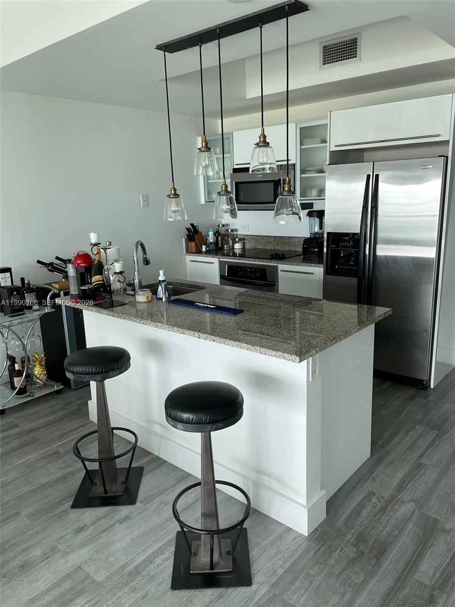 888 Biscayne Boulevard, Unit 1810 Miami, FL 33132 - Photo 22 of 28 a kitchen with counter space cabinets and appliances