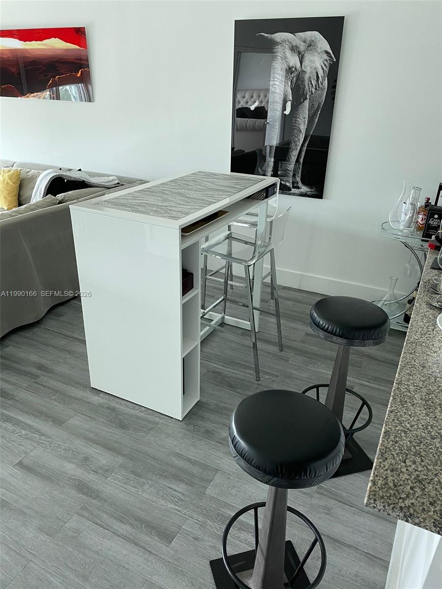 888 Biscayne Boulevard, Unit 1810 Miami, FL 33132 - Photo 25 of 28 a room with furniture and a potted plant