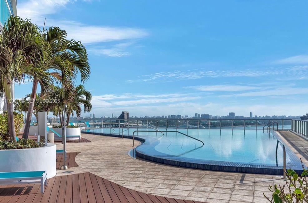 888 Biscayne Boulevard, Unit 1810 Miami, FL 33132 - Photo 6 of 28 a view of a swimming pool with a patio