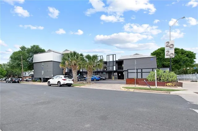 a view of a house with a backyard and sitting area