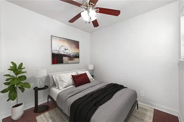 a bedroom with a bed and a potted plant
