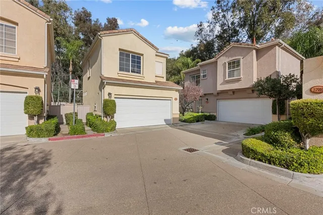 a front view of a house with a yard and a garage