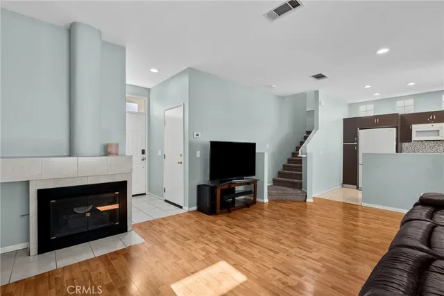 a living room with furniture a fireplace and a flat screen tv