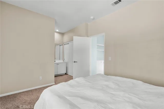 a bedroom with a bed and a cabinets