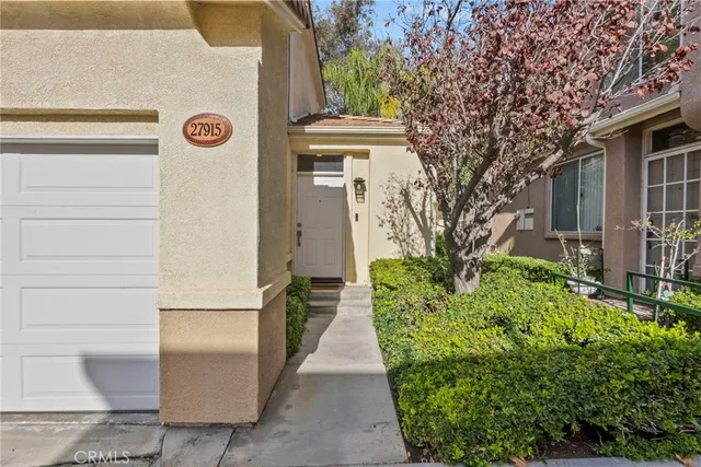 a view of a pathway of house with potted plants