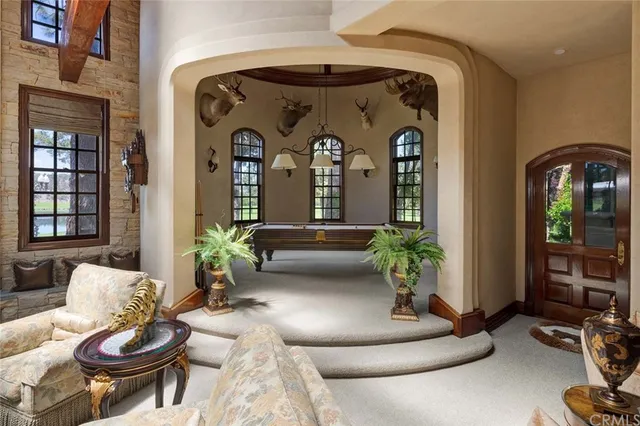 a dining room with furniture a chandelier and wooden floor