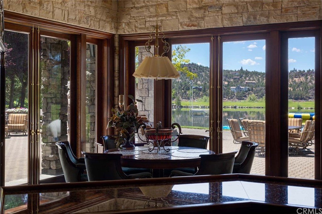 15733 Juniper Peak Road Weed, CA 96094 - Photo 33 of 74 a dining room with large glass windows and furniture