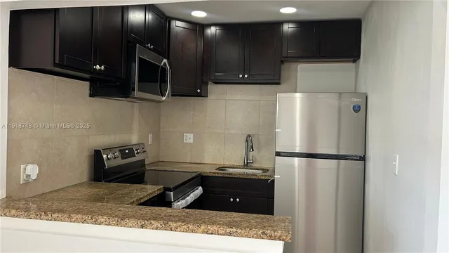 a kitchen with a refrigerator and a stove