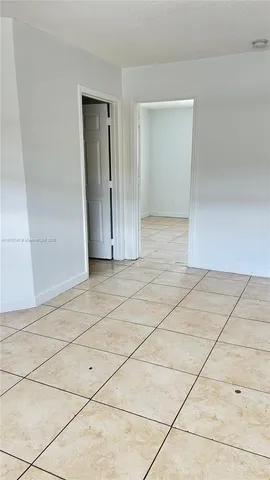 a view of a kitchen with an empty space and a window
