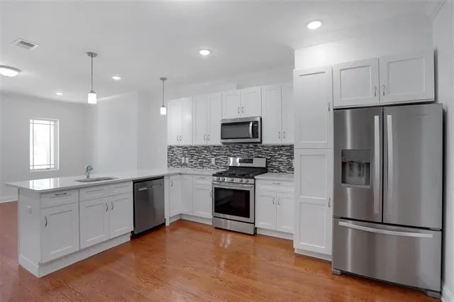 a kitchen with a refrigerator stove and microwave