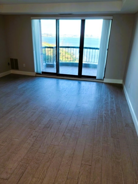 3 Seal Harbor Road, Unit 634 Winthrop, MA 02152 - Photo 6 of 8 a view of an empty room with wooden floor and a window