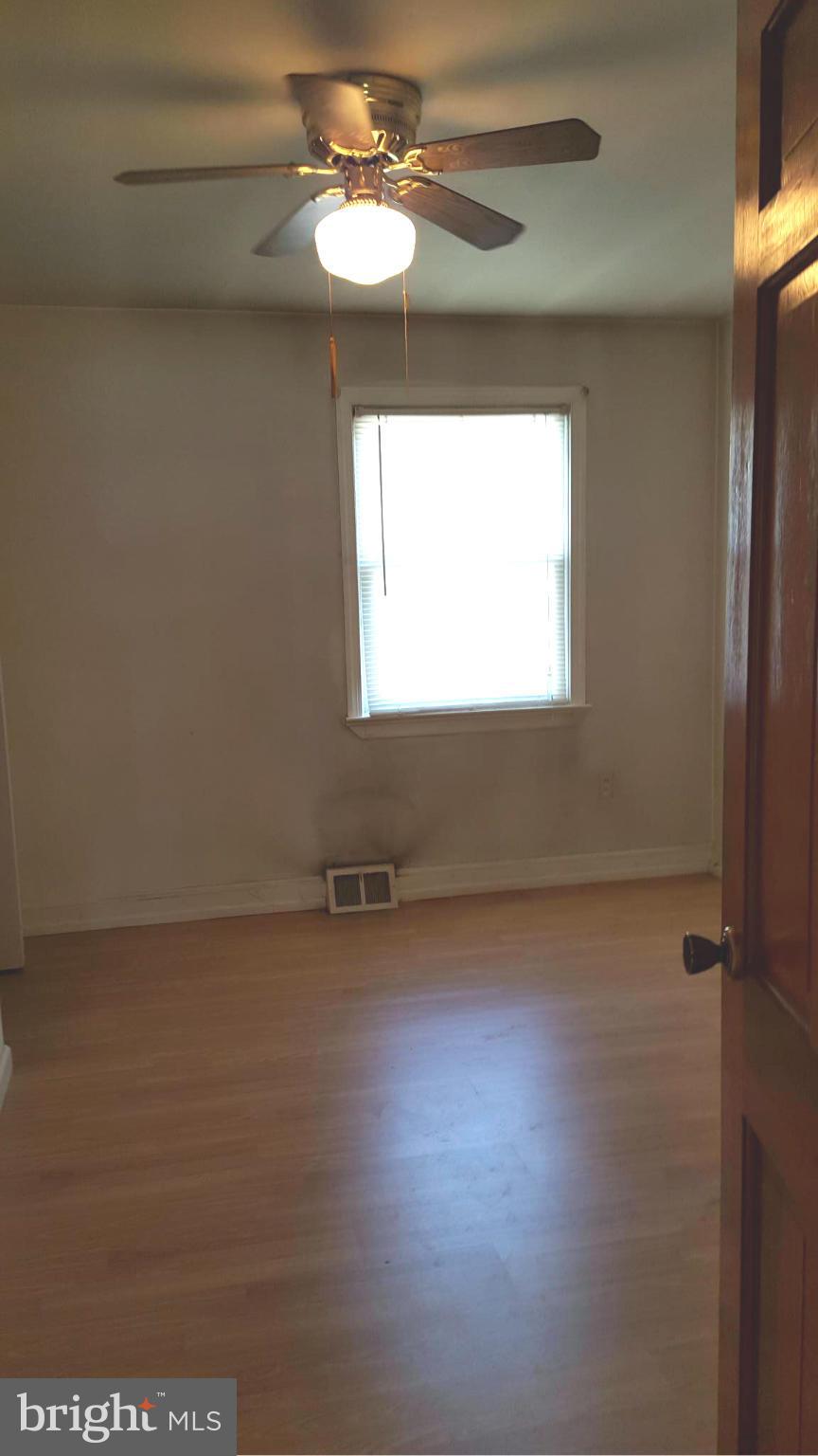 3701 Damascus Road Brookeville, MD 20833 - Photo 13 of 15 en empty room with windows and ceiling fan
