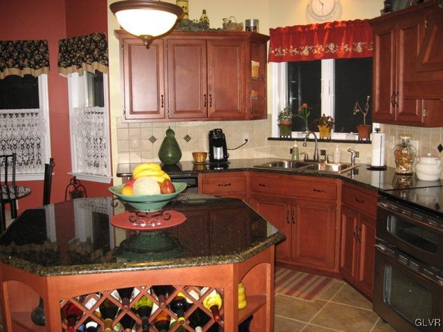 195 West Butternut Road Hellertown, PA 18055 - Photo 11 of 23 a kitchen with stainless steel appliances granite countertop a sink dishwasher and cabinets with wooden floor