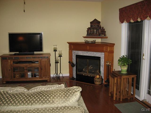 195 West Butternut Road Hellertown, PA 18055 - Photo 7 of 23 a living room with a fireplace a flat screen tv and a couch