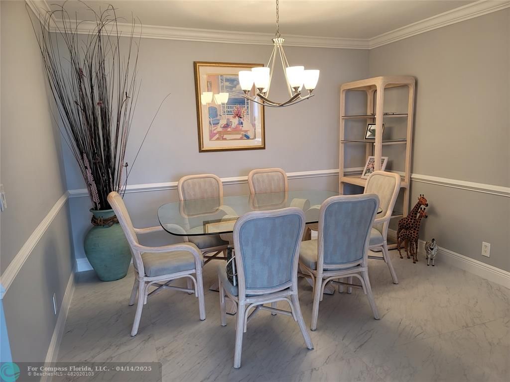 1500 North Ocean Boulevard, Unit 901 Pompano Beach, FL 33062 - Photo 12 of 19 a dining room with furniture a chandelier and window