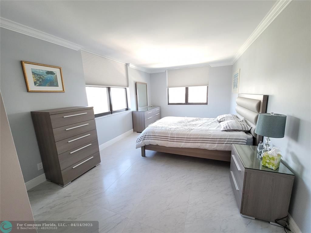 1500 North Ocean Boulevard, Unit 901 Pompano Beach, FL 33062 - Photo 14 of 19 a bedroom with a bed and furniture