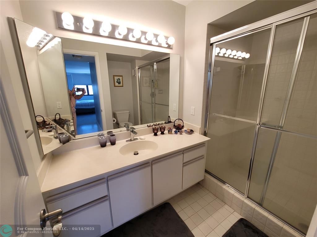 1500 North Ocean Boulevard, Unit 901 Pompano Beach, FL 33062 - Photo 15 of 19 a bathroom with a double vanity sink and a mirror