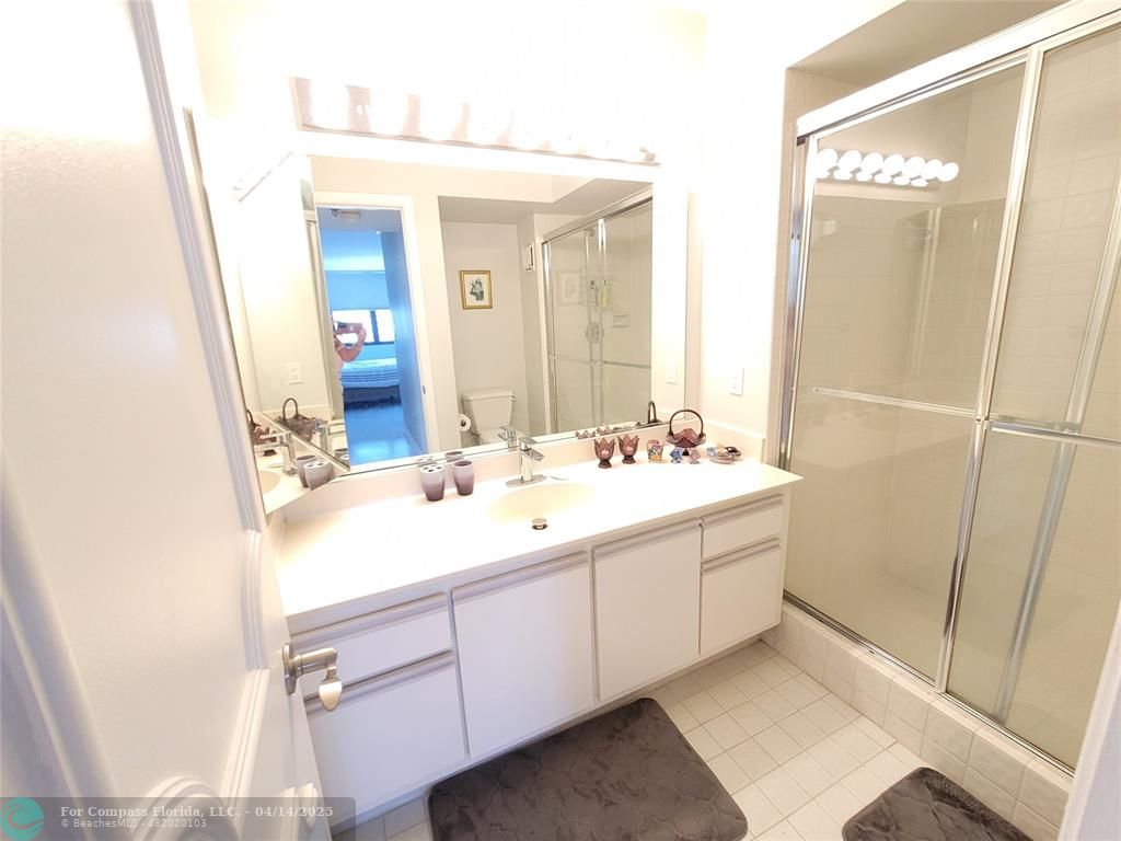 1500 North Ocean Boulevard, Unit 901 Pompano Beach, FL 33062 - Photo 17 of 19 a bathroom with a sink and a mirror