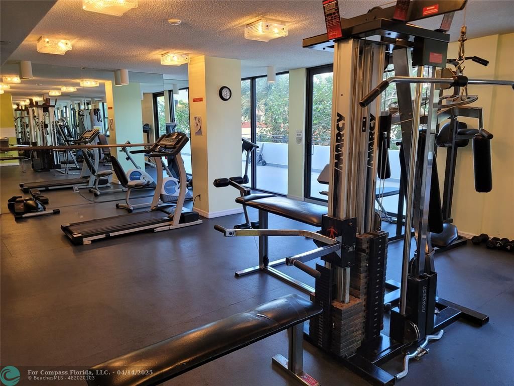 1500 North Ocean Boulevard, Unit 901 Pompano Beach, FL 33062 - Photo 4 of 19 a view of a room with gym equipment