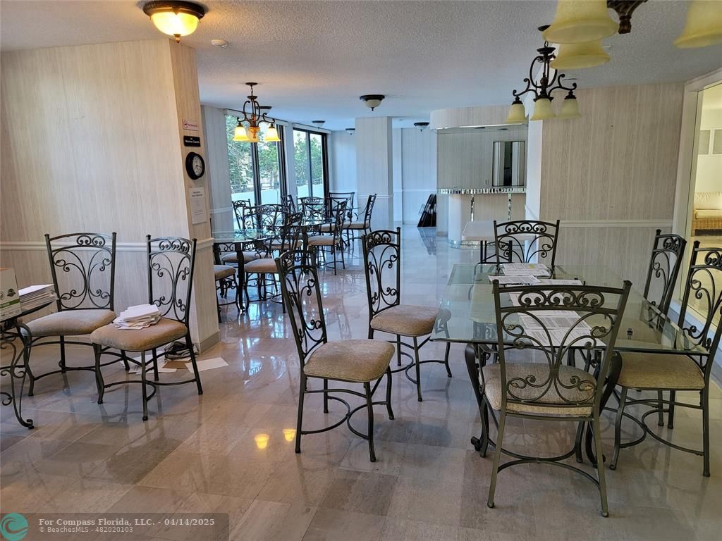 1500 North Ocean Boulevard, Unit 901 Pompano Beach, FL 33062 - Photo 6 of 19 a view of a dining room with furniture and chandelier