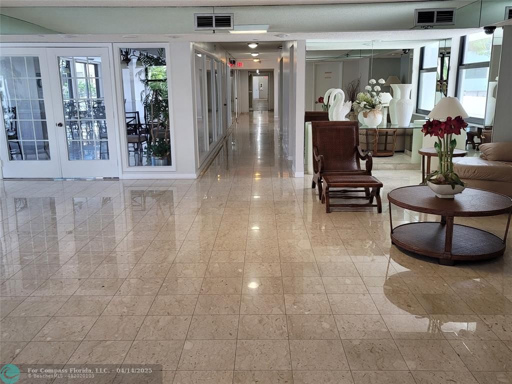 1500 North Ocean Boulevard, Unit 901 Pompano Beach, FL 33062 - Photo 9 of 19 a living room with furniture and a potted plant