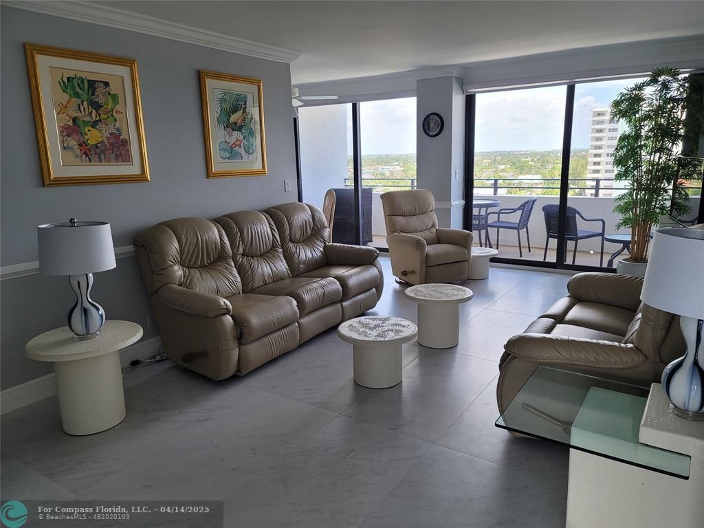 1500 North Ocean Boulevard, Unit 901 Pompano Beach, FL 33062 - Photo 10 of 19 a living room with furniture and floor to ceiling windows
