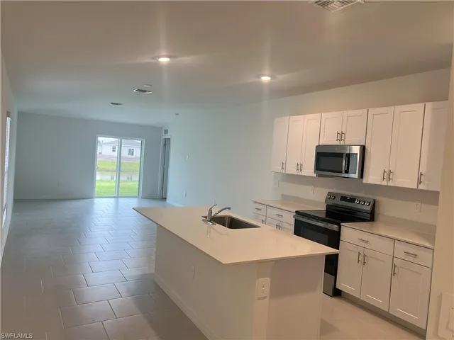 a kitchen with a refrigerator and cabinets