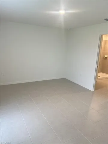 a kitchen that has a lot of cabinets in it and wooden floors