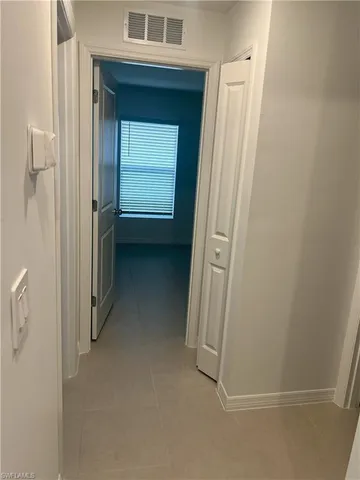 a kitchen with stainless steel appliances a white stove top oven and white cabinets
