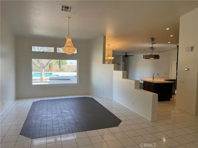 a view of a room with window and chandelier
