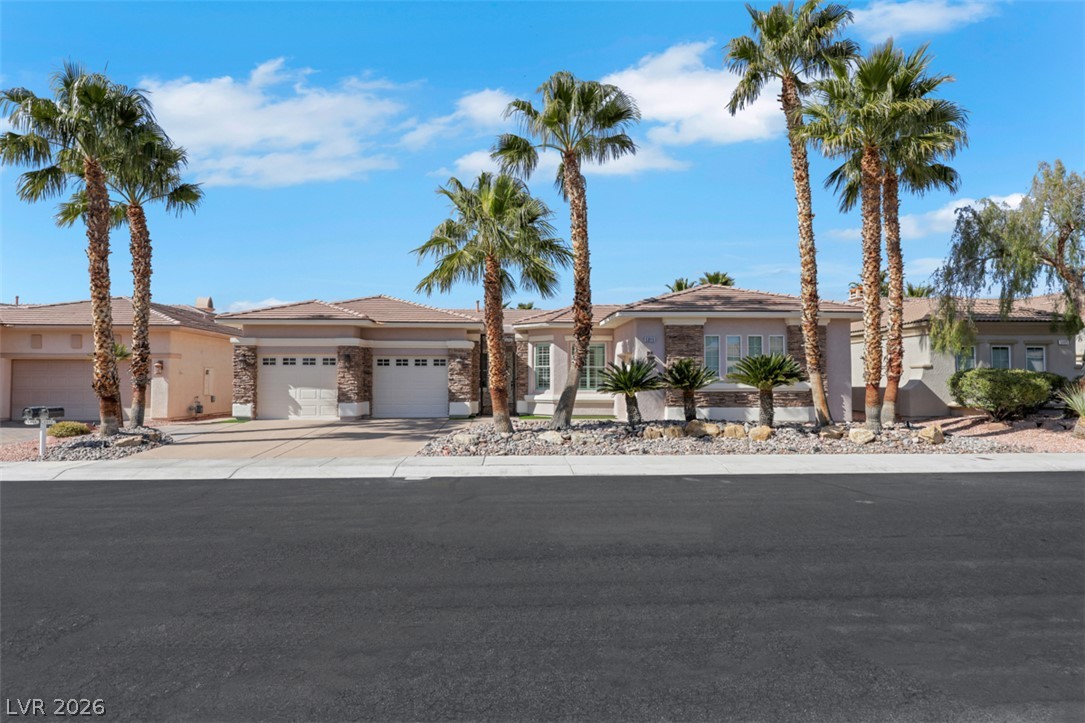 5015 Rivedro Street Las Vegas, NV 89135 - Photo 57 of 91 A desert-adapted facade featuring natural stone accents and multiple garages awaits.