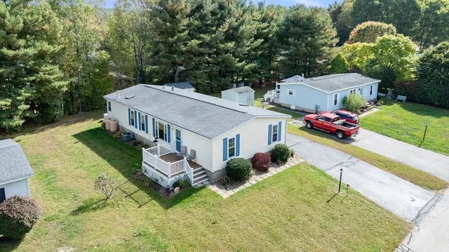 an aerial view of a house with a garden and pool