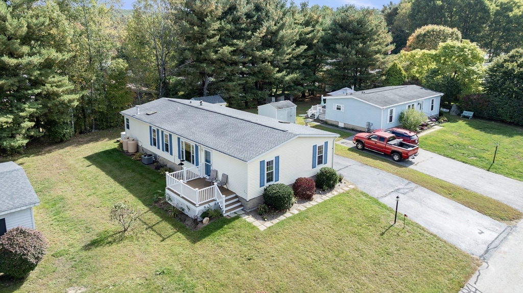an aerial view of a house with a garden and pool