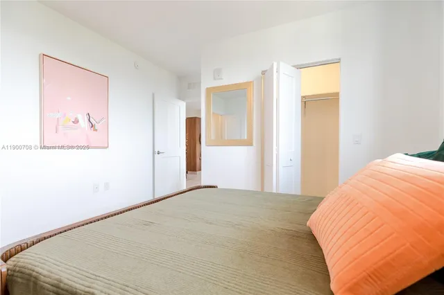 a bedroom with a bed and a painting on the wall