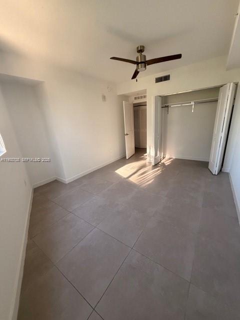 1005 Spring Garden Road, Unit 220 Miami, FL 33136 - Photo 3 of 35 en empty room with windows and ceiling fan