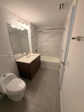 a bathroom with a sink a toilet and a bathtub