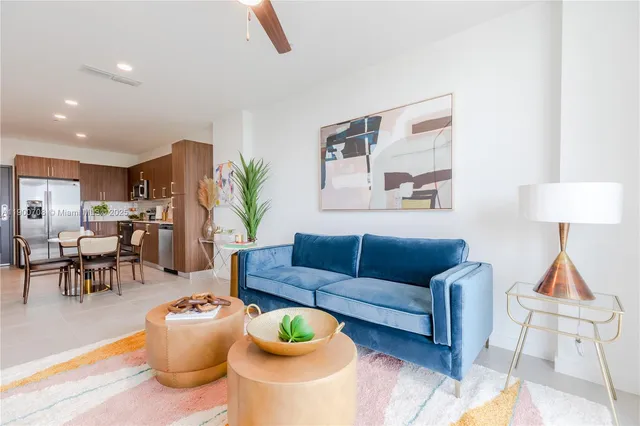 a living room with furniture and a lamp