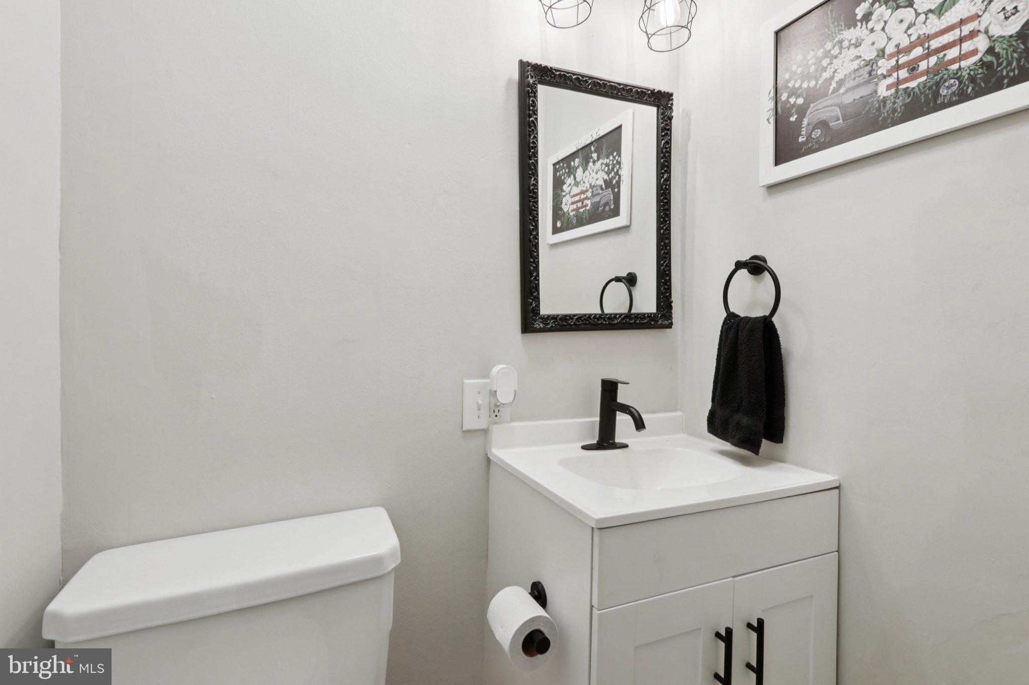 418 Walnut Street Pottstown, PA 19464 - Photo 24 of 52 a bathroom with a toilet sink and mirror