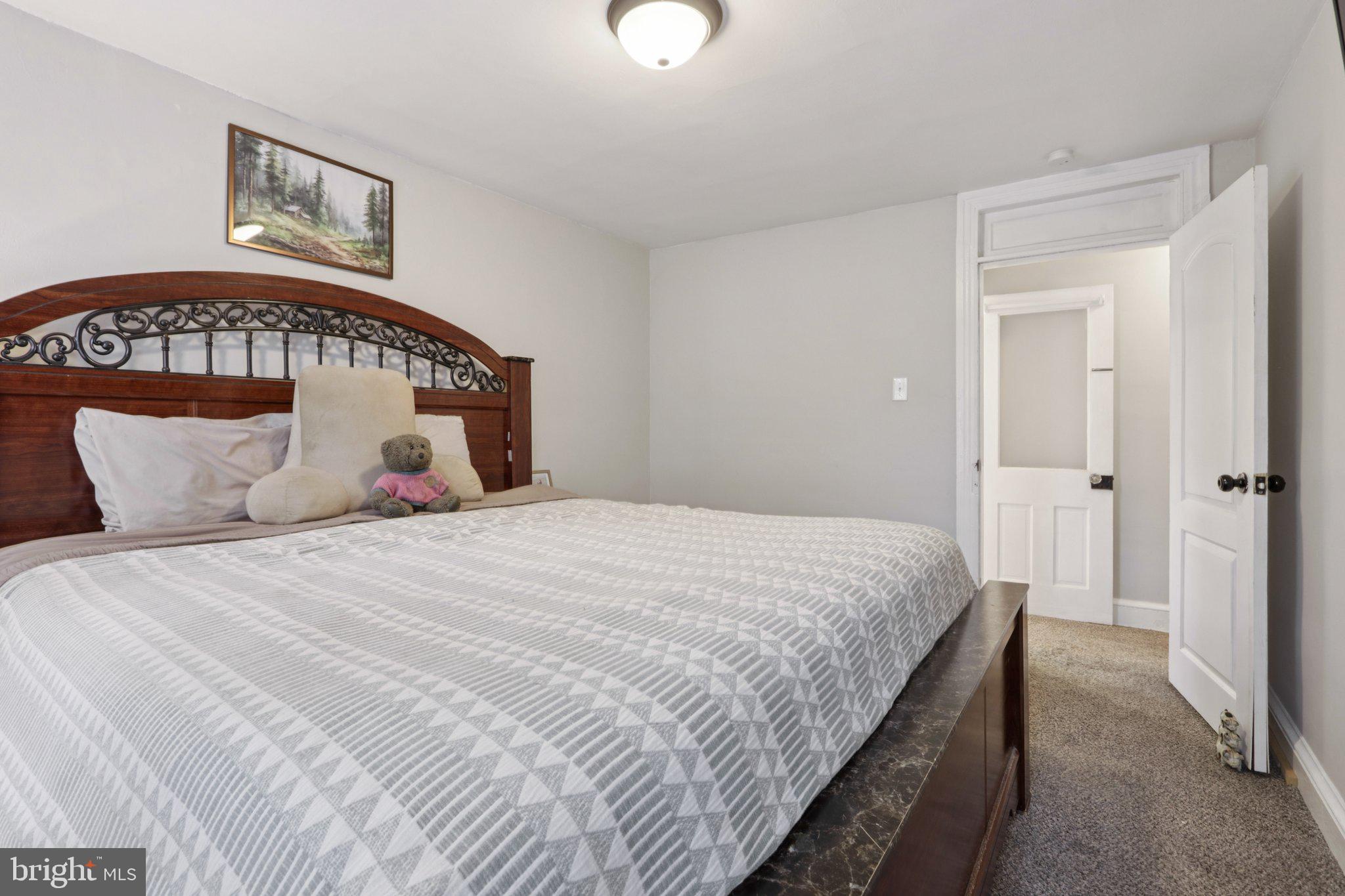 418 Walnut Street Pottstown, PA 19464 - Photo 25 of 52 a bedroom with a large bed and a chandelier
