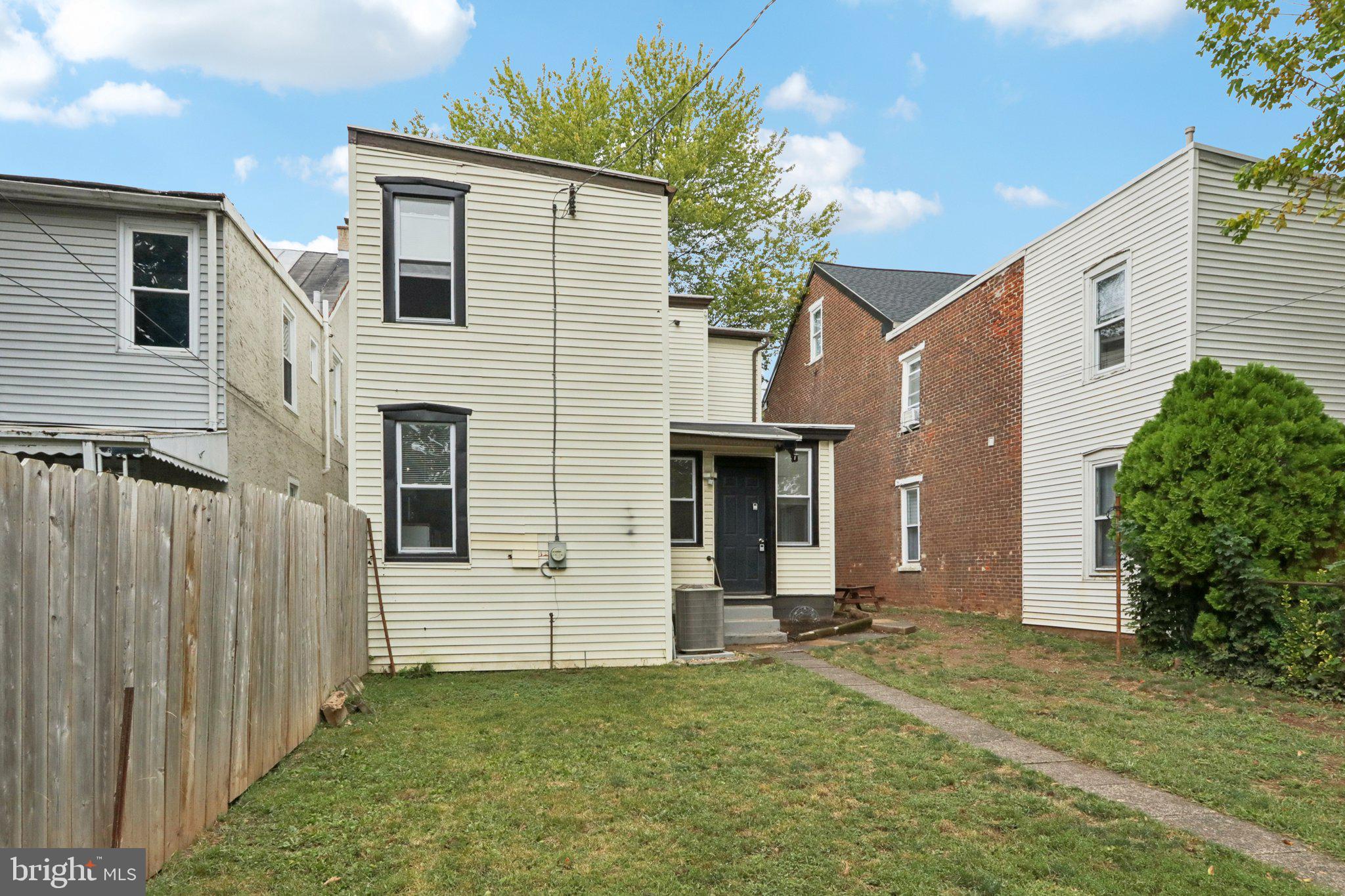 418 Walnut Street Pottstown, PA 19464 - Photo 35 of 52 a view of a white house with a small yard and a large window