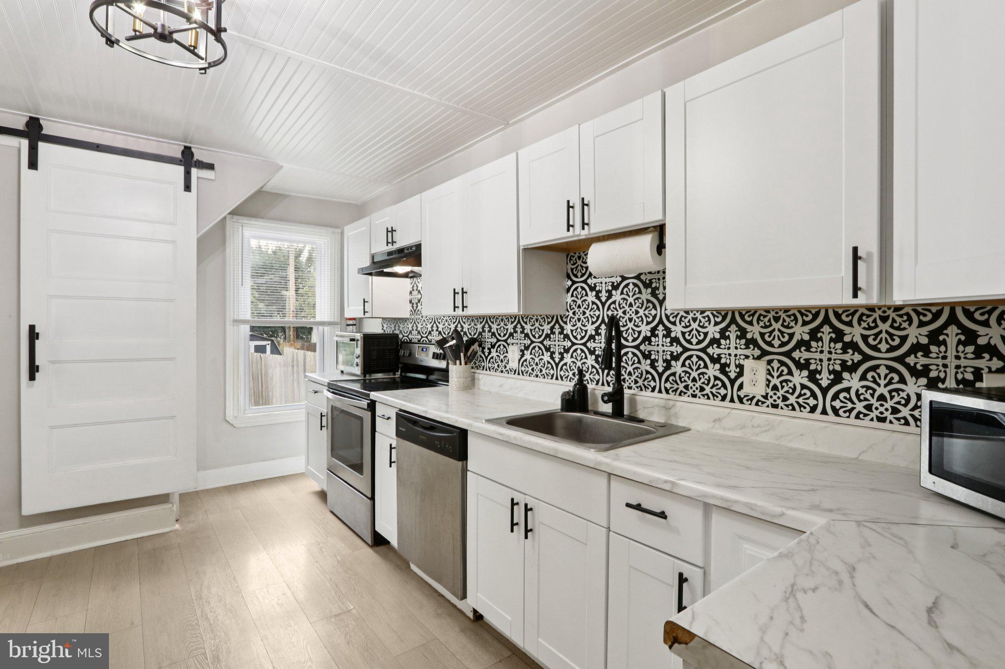 418 Walnut Street Pottstown, PA 19464 - Photo 7 of 52 a kitchen with stainless steel appliances granite countertop a sink stove and refrigerator