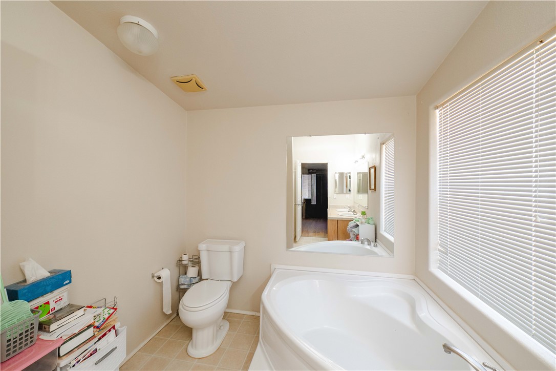 4729 Stewart Mountain Road Golden Valley, AZ 86413 - Photo 14 of 28 a bathroom with a toilet sink and mirror