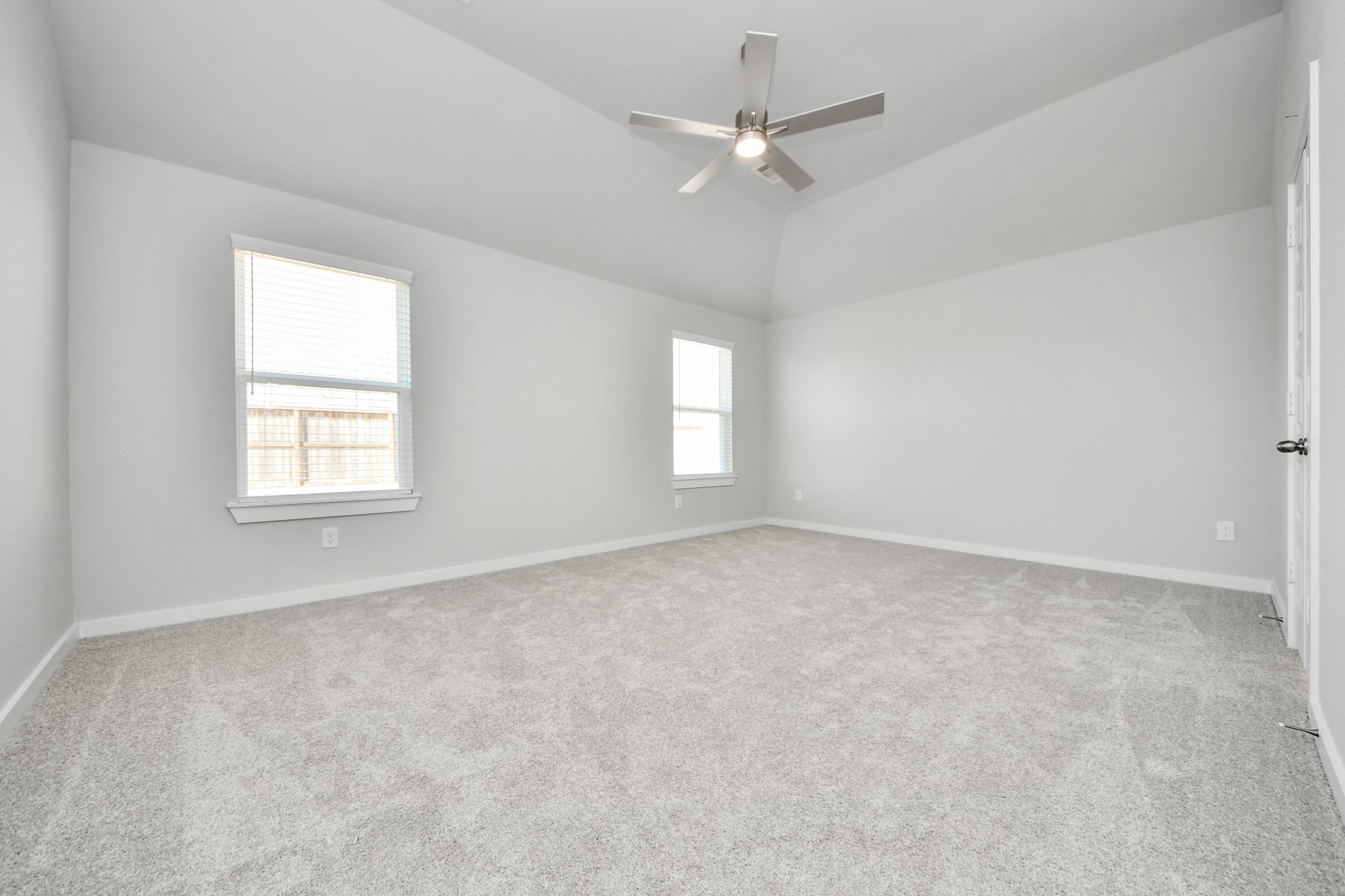 311 Ice Shr Trail Dayton, TX 77535 - Photo 24 of 35 Escape to tranquility in this spacious primary room, adorned with plush carpeting and bathed in the soothing hues of warm paint colors, creating a cozy retreat for relaxation. Sample photo of completed home with similar floor plan. Actual colors and selections may vary.