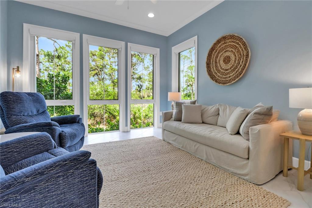 6509 Dominica Drive, Unit 101 Naples, FL 34113 - Photo 12 of 33 a living room with furniture and a large window