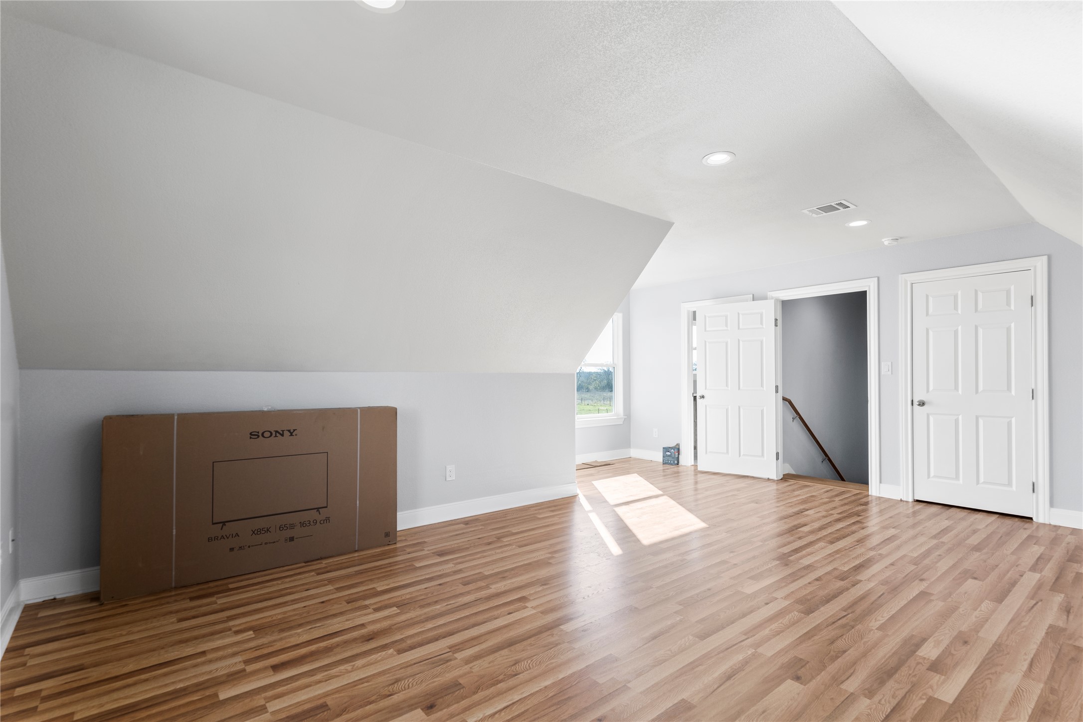 1434 Antioch Road Paige, TX 78659 - Photo 26 of 40 Your Needs for your Additional living space featuring vaulted ceiling, light wood-style flooring, and recessed lighting