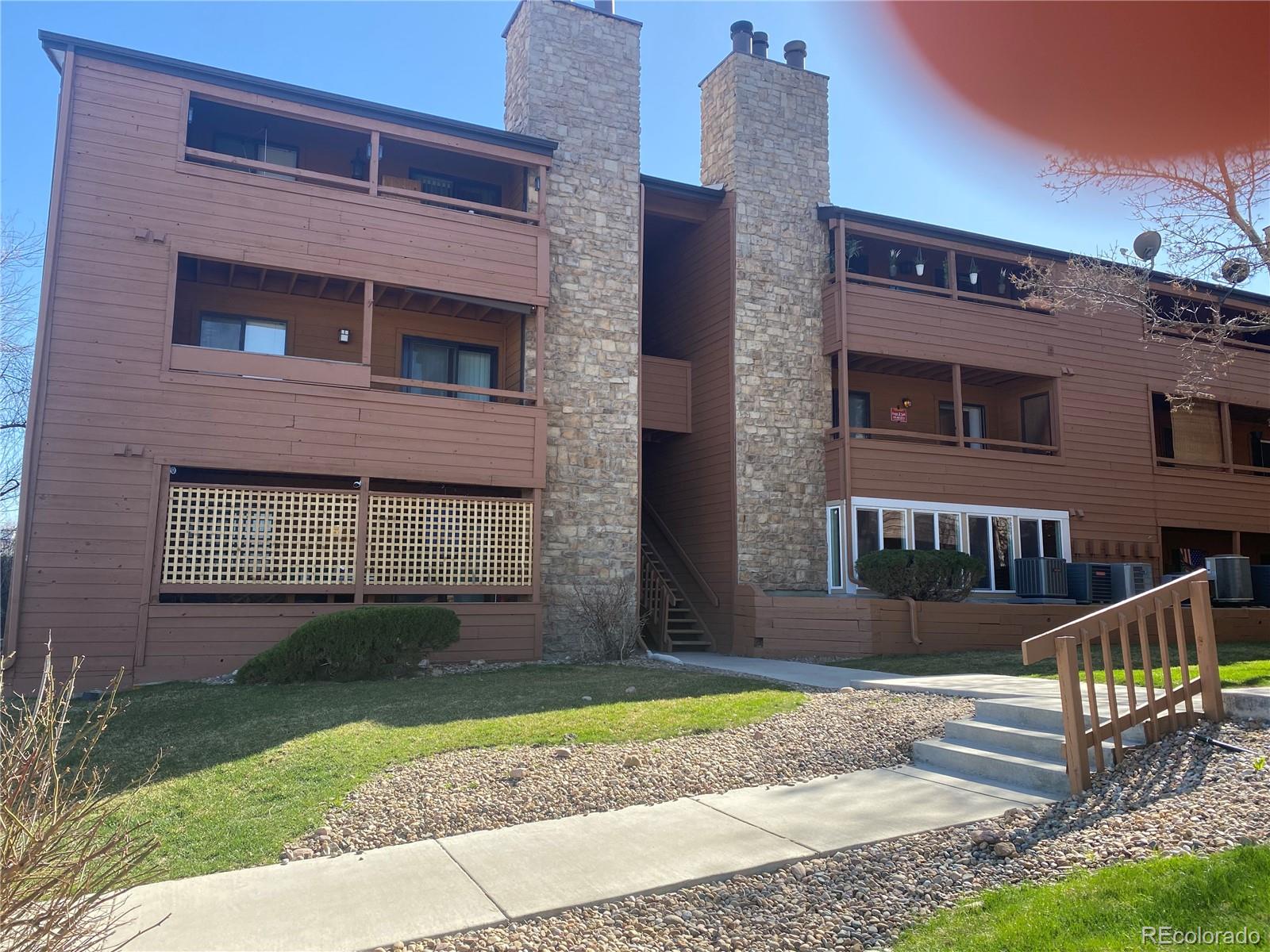4671 South Decatur Street, Unit 232 Englewood, CO 80110 - Photo 1 of 32 a front view of a house with a yard