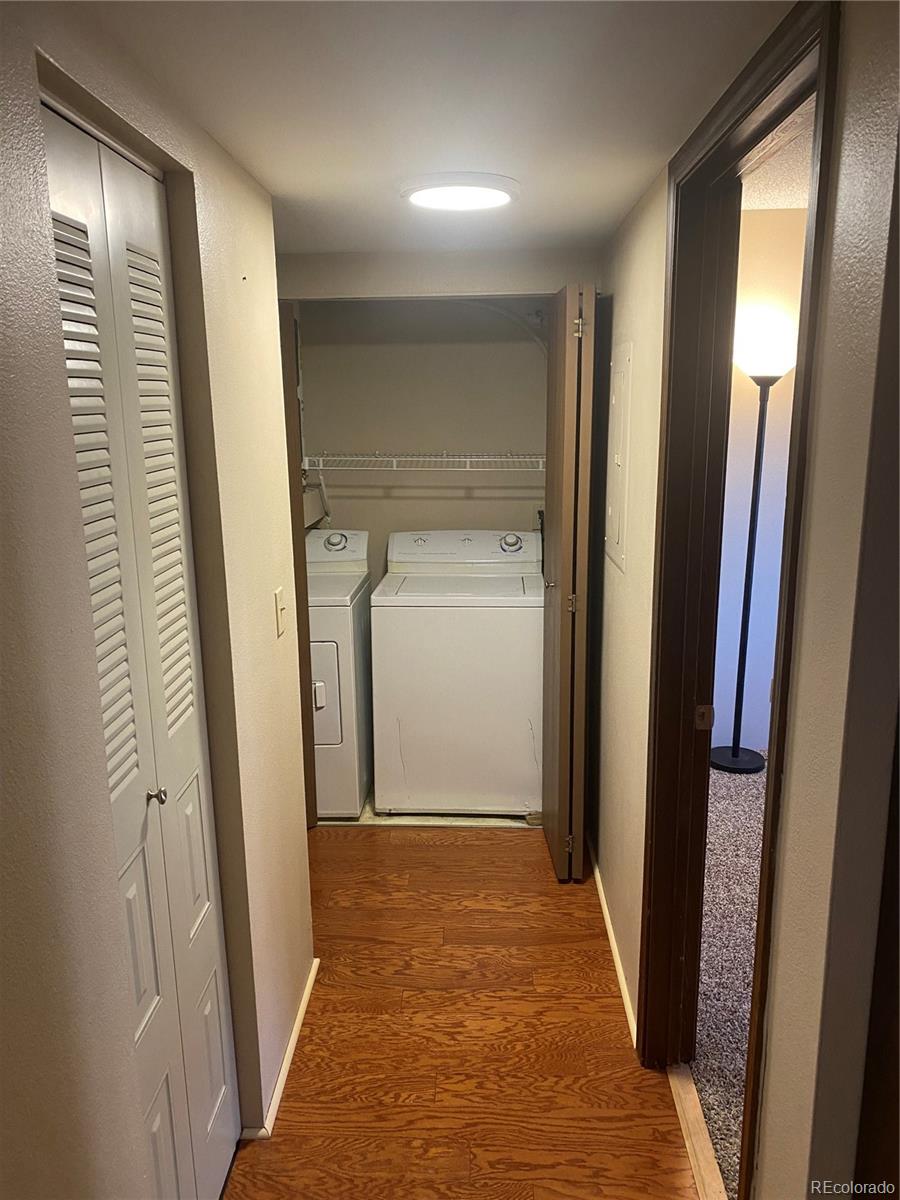 4671 South Decatur Street, Unit 232 Englewood, CO 80110 - Photo 12 of 32 a view of a hallway with wooden floor and stairs