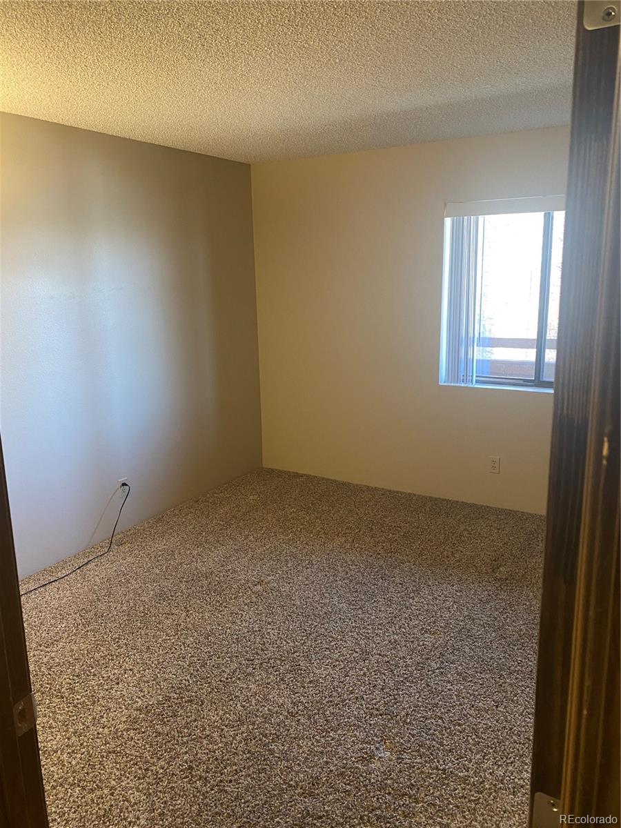 4671 South Decatur Street, Unit 232 Englewood, CO 80110 - Photo 14 of 32 an empty room with a workbench