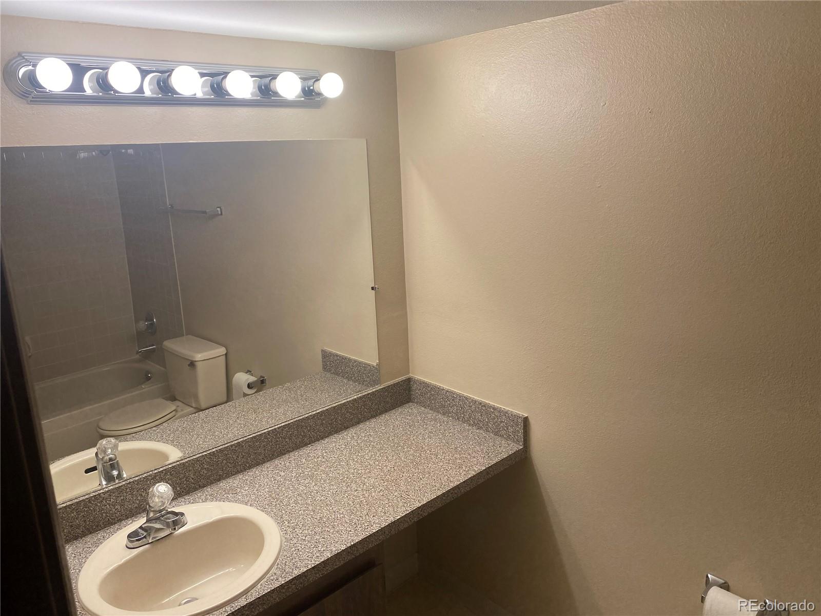 4671 South Decatur Street, Unit 232 Englewood, CO 80110 - Photo 19 of 32 a bathroom with a sink and a mirror