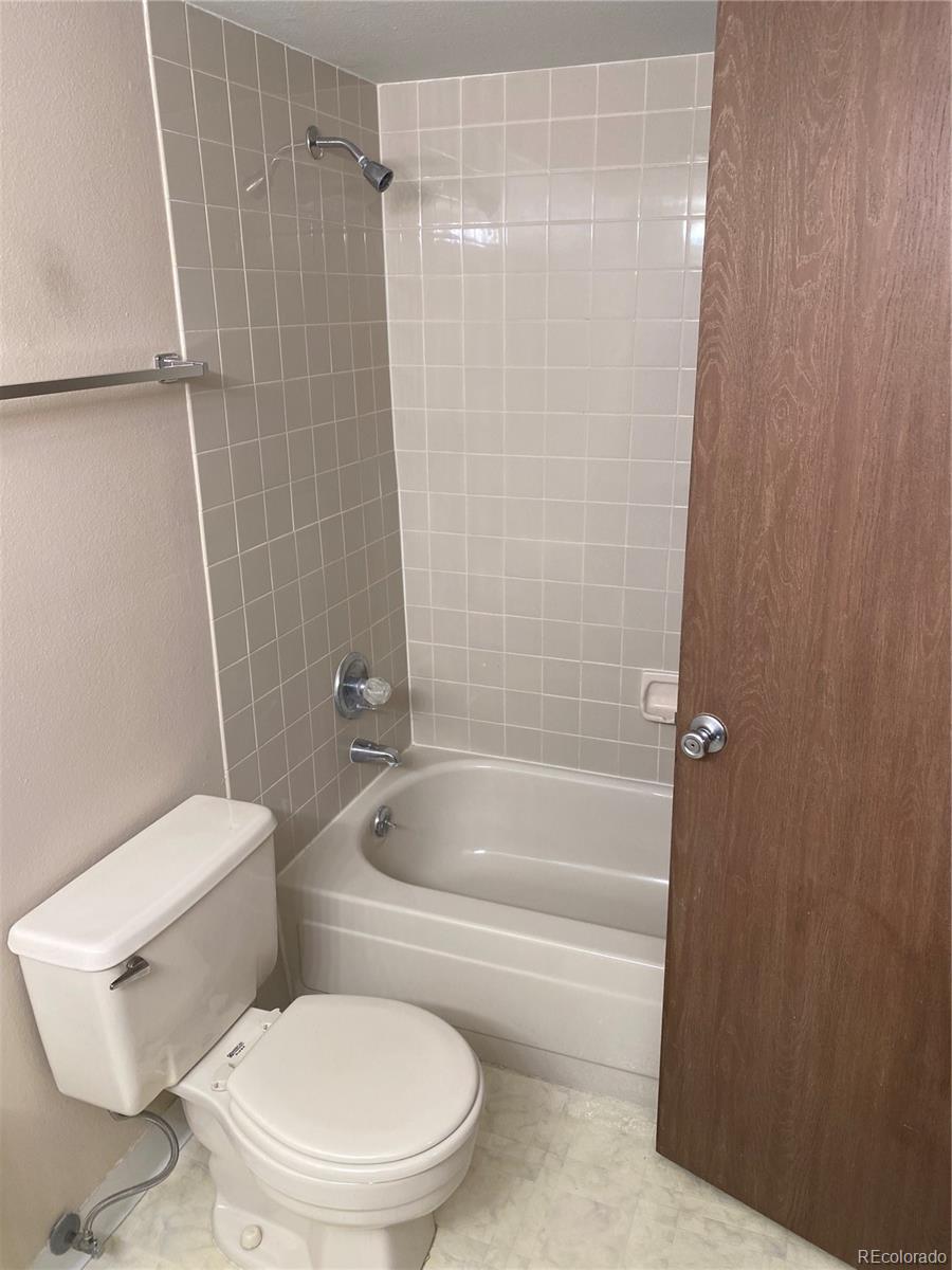 4671 South Decatur Street, Unit 232 Englewood, CO 80110 - Photo 20 of 32 a white toilet and tub sitting next to a bathroom sink